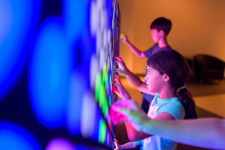 Children changing colors of the light wall